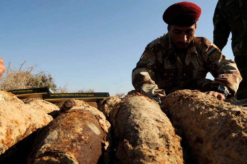 Iraqi army Explosive Ordnance Disposal team clear base of old munitions