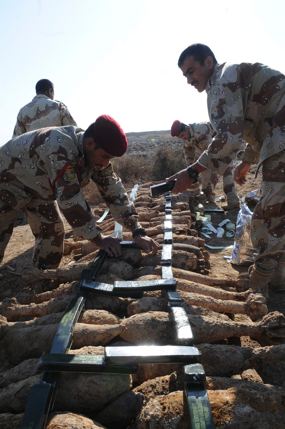 Iraqi army Explosive Ordnance Disposal team clear base of old munitions