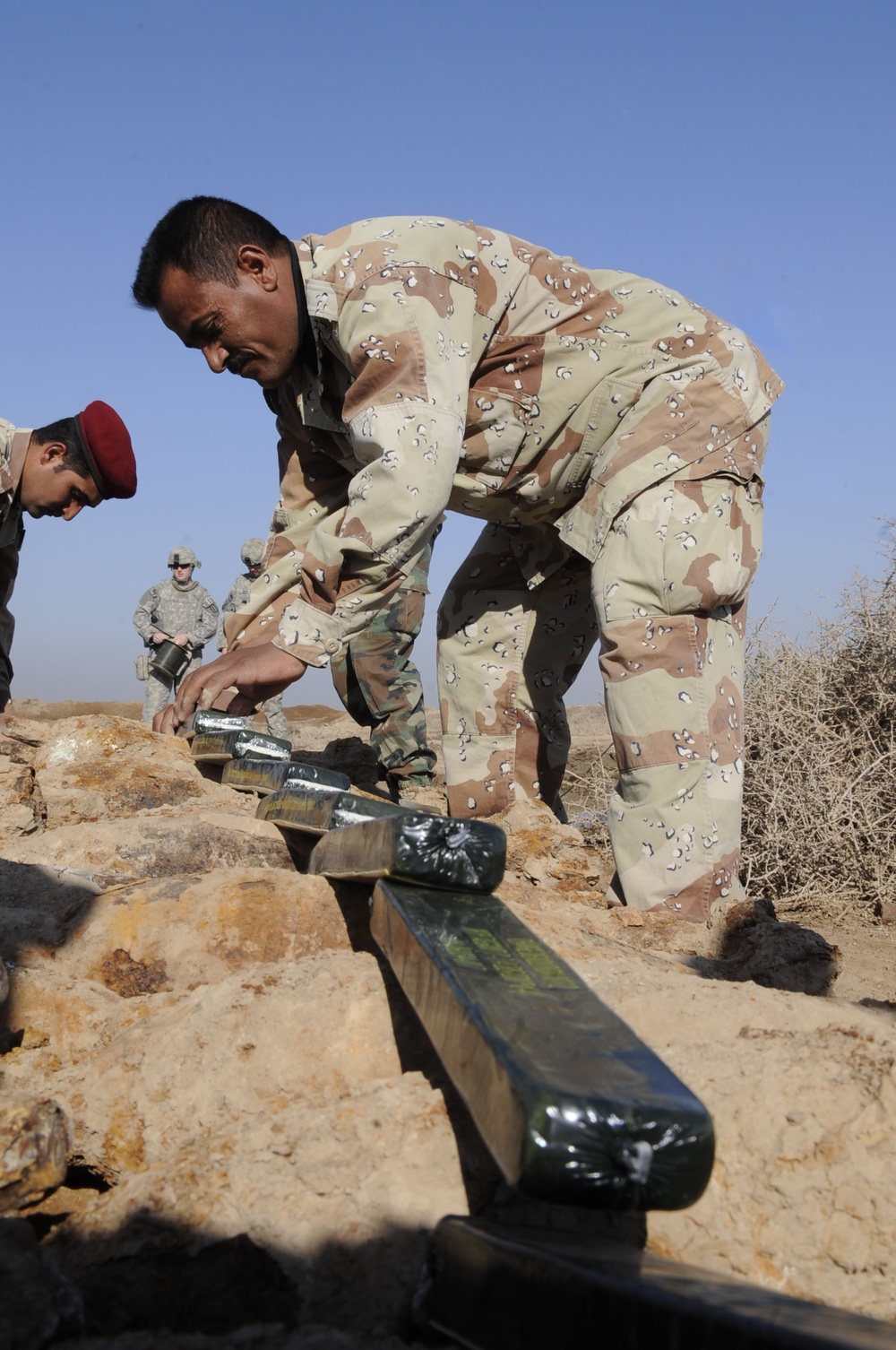 Iraqi army Explosive Ordnance Disposal team clear base of old munitions