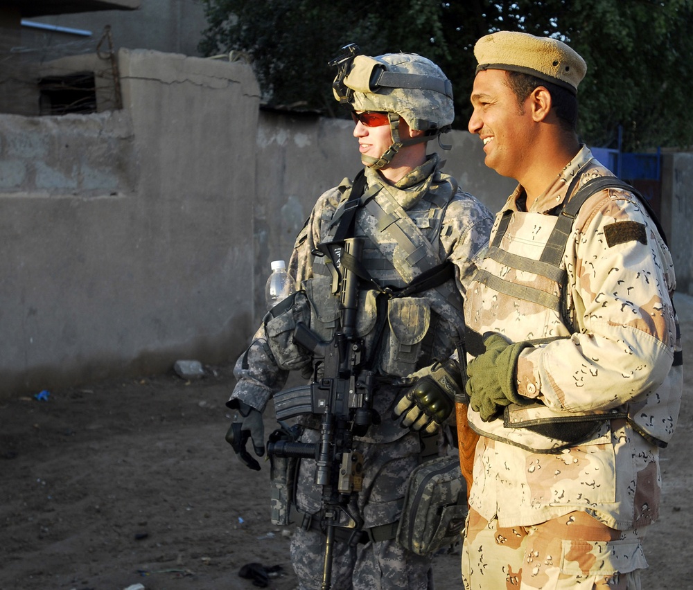 Iraqi army soldiers stand in lead during joint patrol