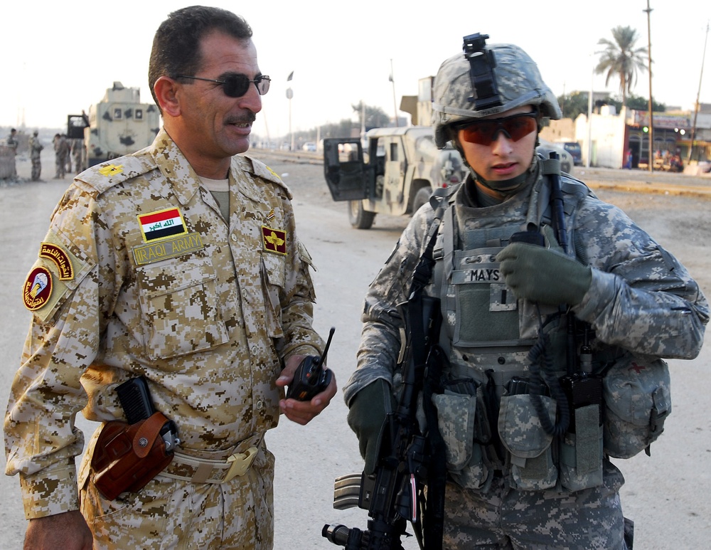 Iraqi army soldiers stand in lead during joint patrol