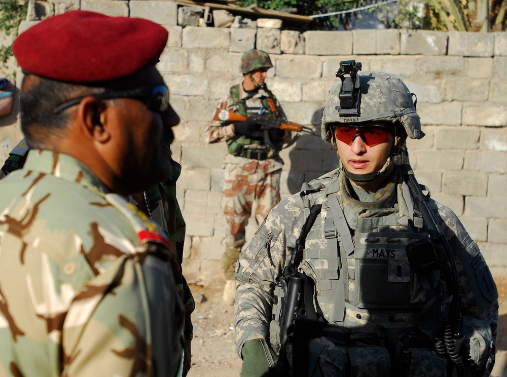 Iraqi army soldiers stand in lead during joint patrol