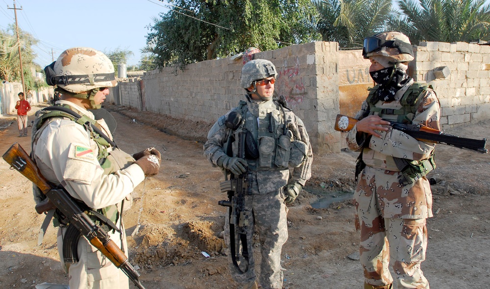 Iraqi army soldiers stand in lead during joint patrol