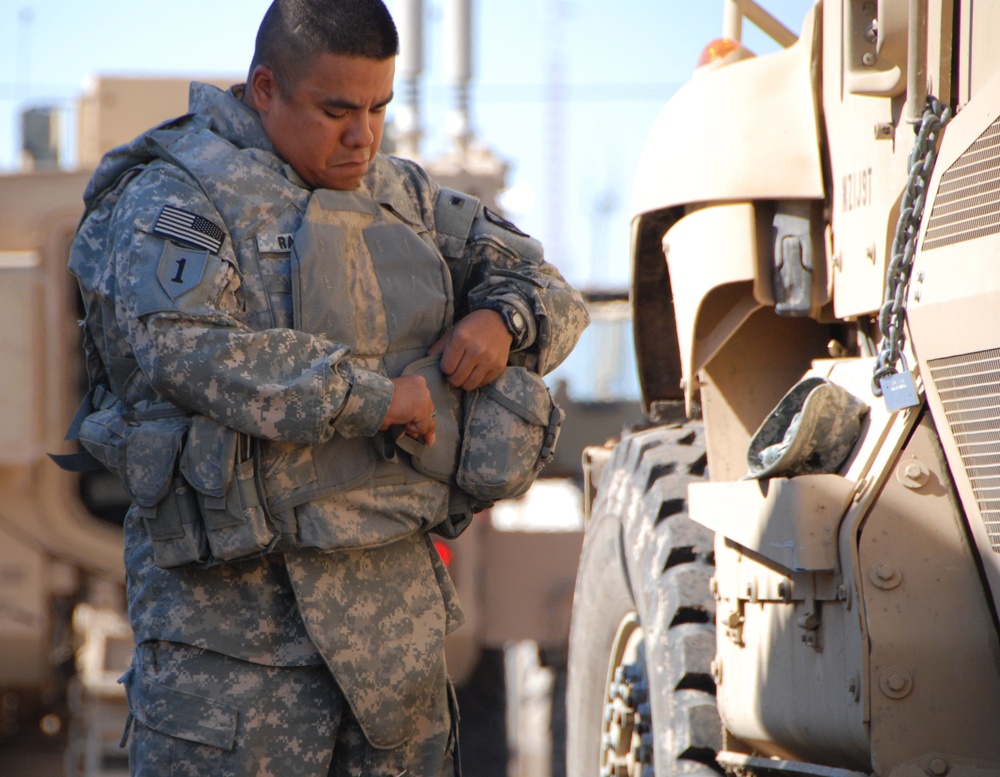 Sgt. Salvador Ramirez, a native of Vernon, Texas, and driver for the 1st Sustainment Brigade personal security detail, dons his gear before heading out on a mission, Nov. 10. The team safely escorted members of the brigade to Joint Base Balad for a mass r