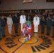 Soldiers, Sailors, Airmen and Junior Reserve Officer Training Corps cadets gather around the roses laid in honor of fallen veterans during the Veterans Day program at Fair Park High School in Shreveport, La., Nov. 11.