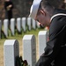 A 2nd class petty officer of the Navy lays a wreath on a fallen Veteran's tombstone during a Wreaths Across America Ceremony at the Alfred G. Horton, Jr. Memorial Veterans Cemetery. Wreaths Across America's mission is to remember the fallen, honor those w