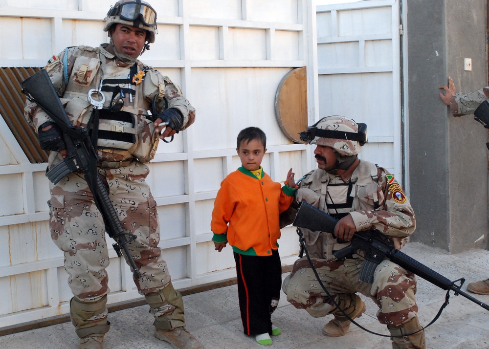 Iraqi Security Forces, Multi-National Division - Baghdad Soldiers patrols the neighborhood of Abu Ghuraib