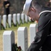 A Sailor lays a wreath on a fallen veteran's tombstone during a Wreaths Across America Ceremony at the Alfred G. Horton, Jr. Memorial Veterans Cemetery. Wreaths Across America is a program to remember the fallen, honor those who serve and teach children t