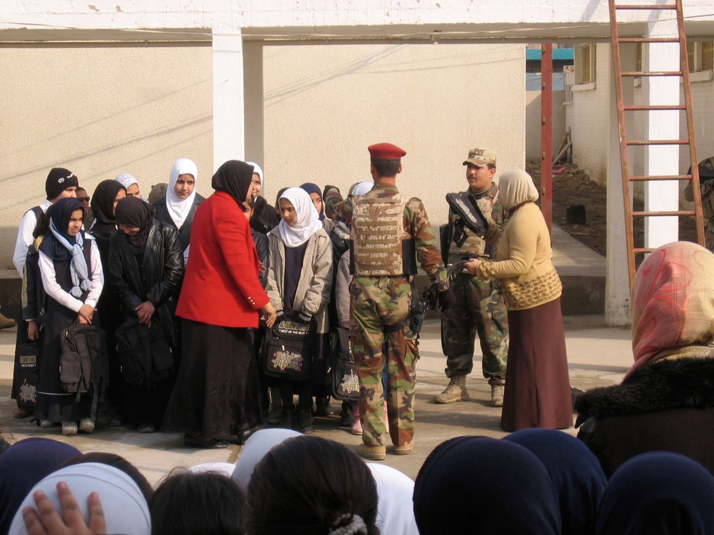 Soldiers provide assistance to girls of al-Nahareen school