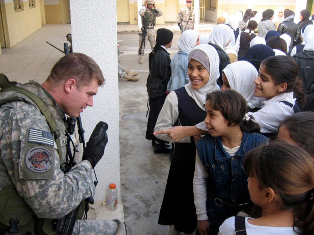 Soldiers provide assistance to girls of al-Nahareen school
