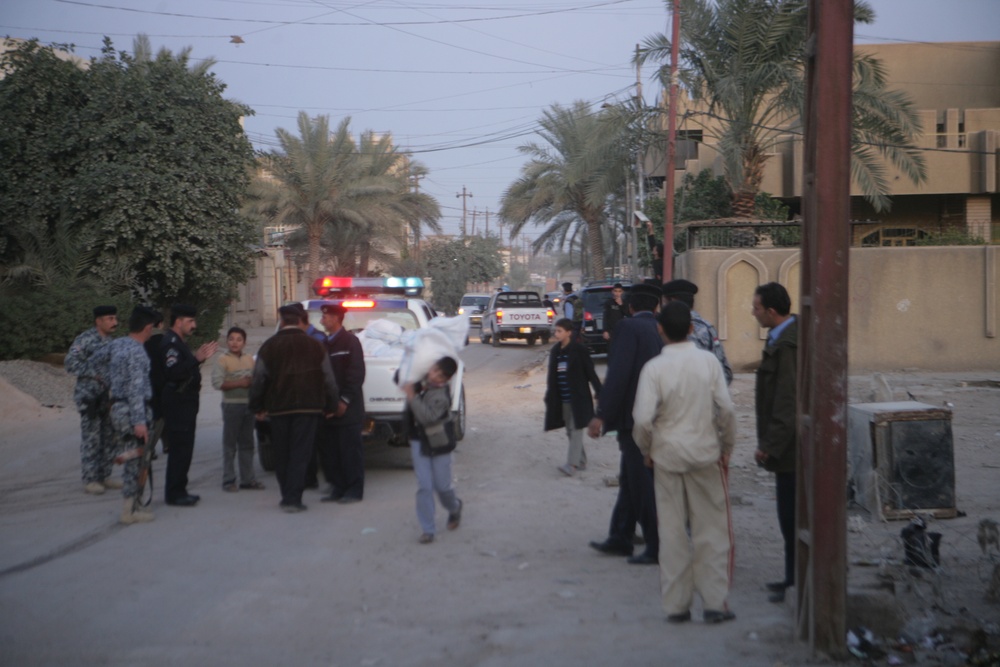 Iraqi police distribute candy, food in Andaloos precint