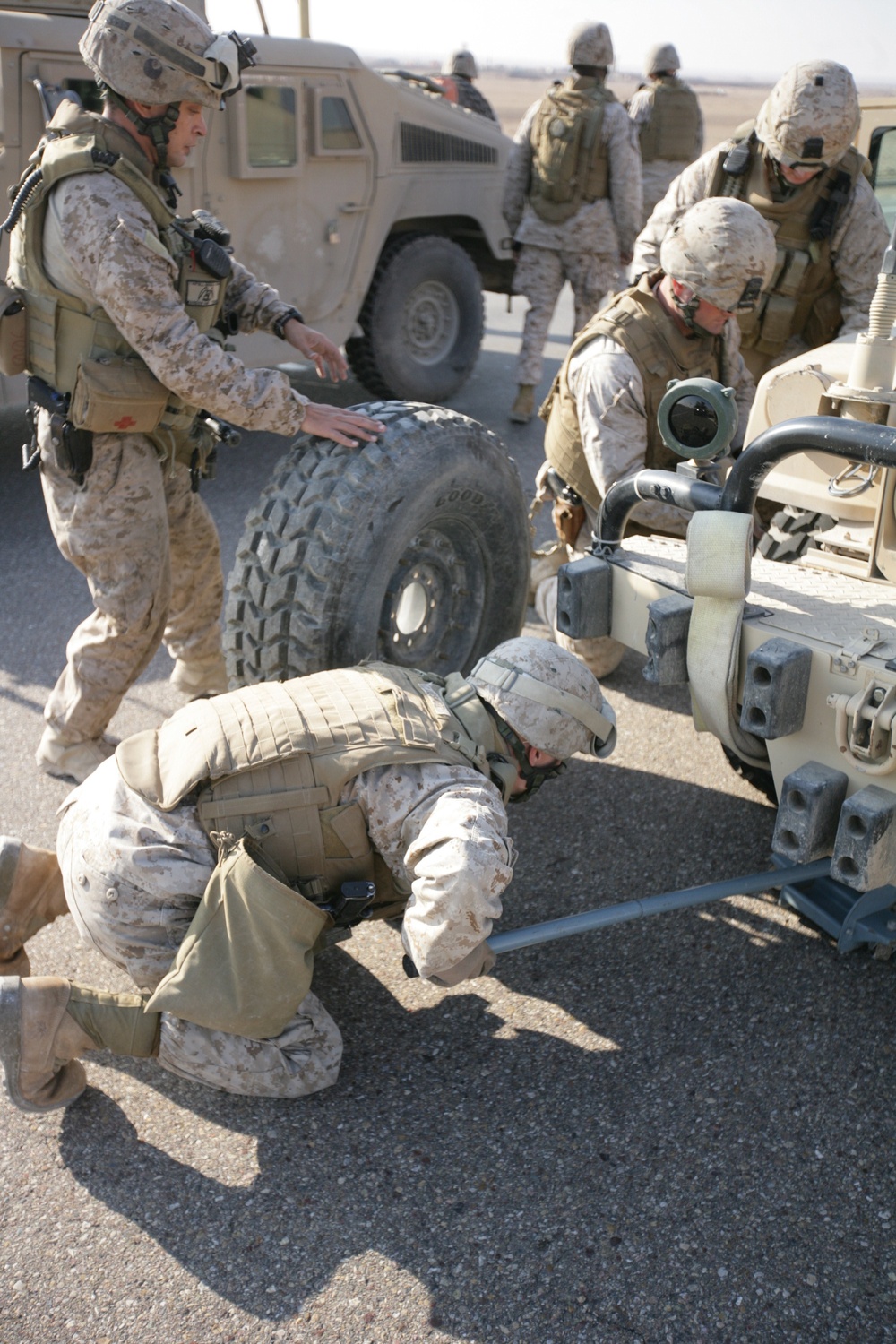 Security Marines change tire during mission