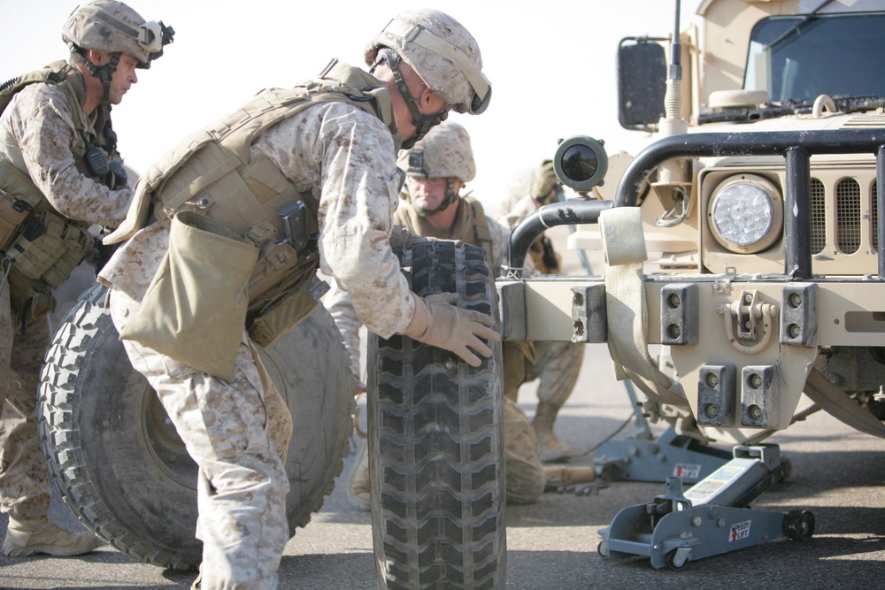 Security Marines change tire during mission