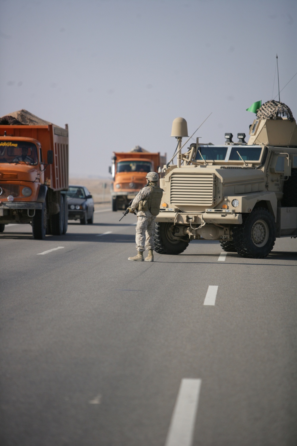 Security Marines change tire during mission