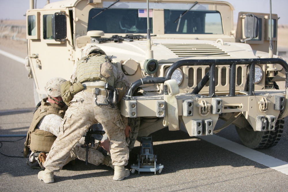 Security Marines change tire during mission