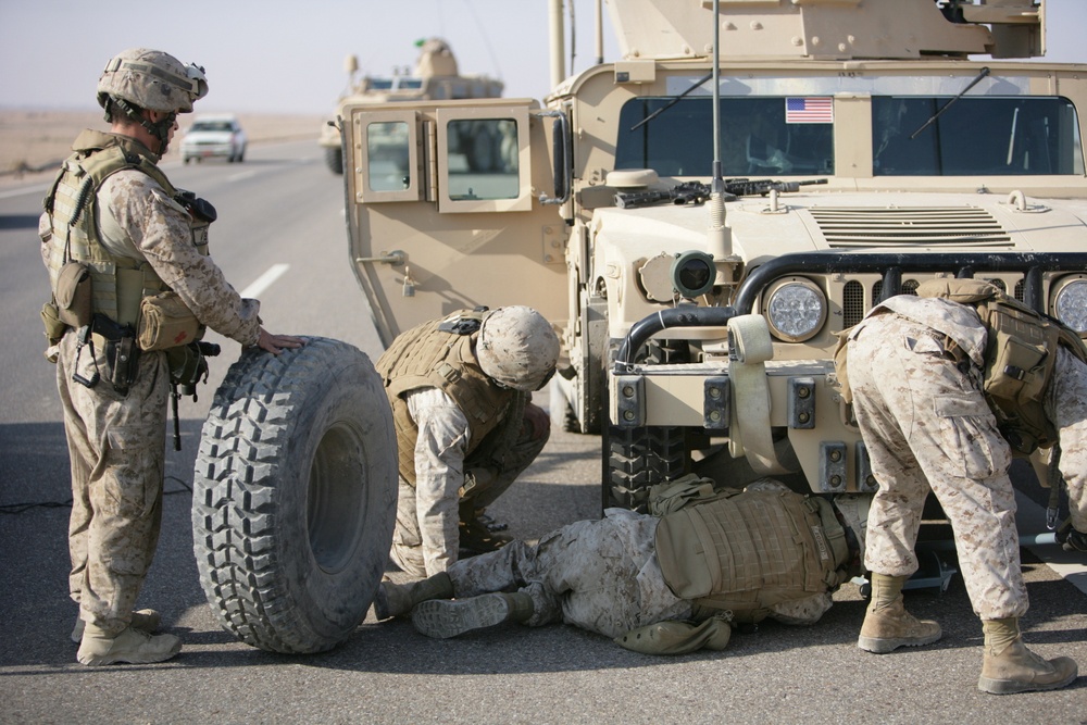 Security Marines change tire during mission