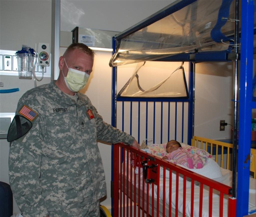 Soldiers bring Christmas spirit to ailing children