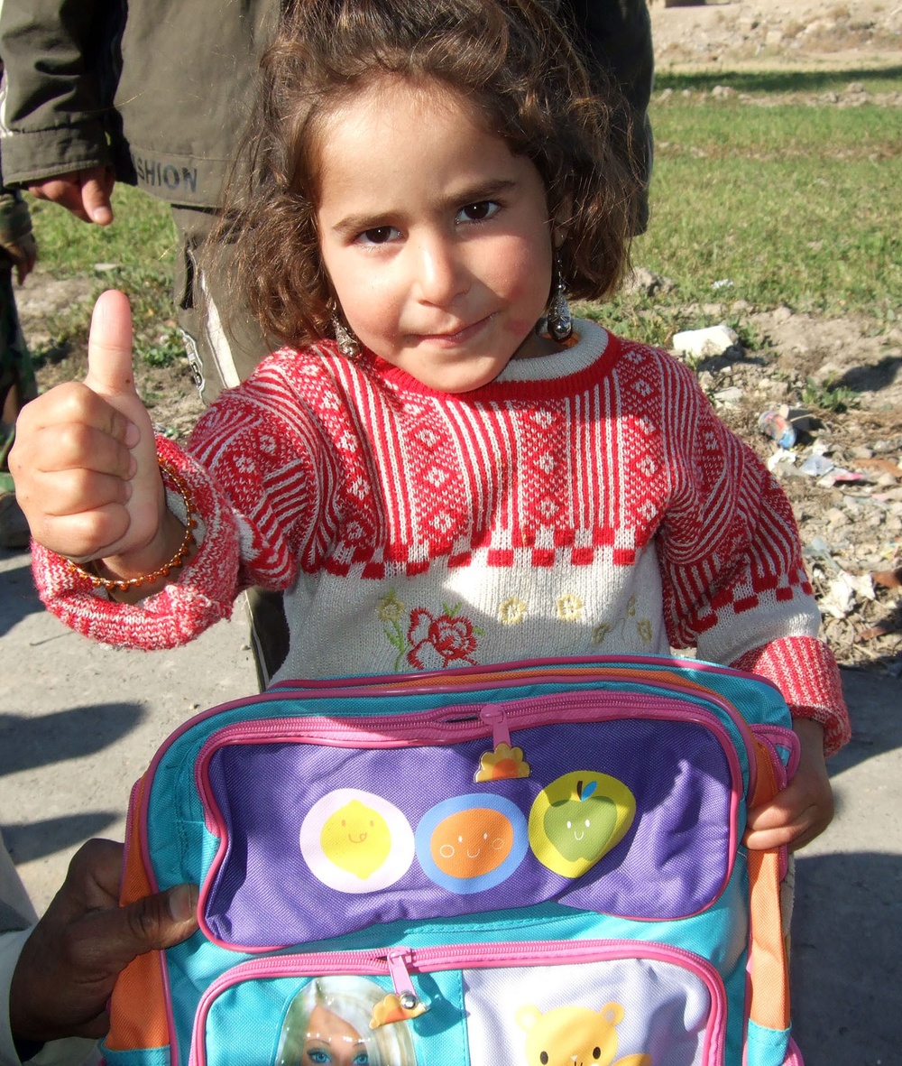 Soldiers help children start New Year off right with new school supplies