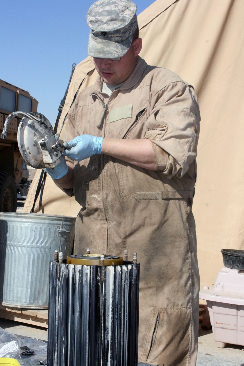 Cavalry soldiers maintain vehicles