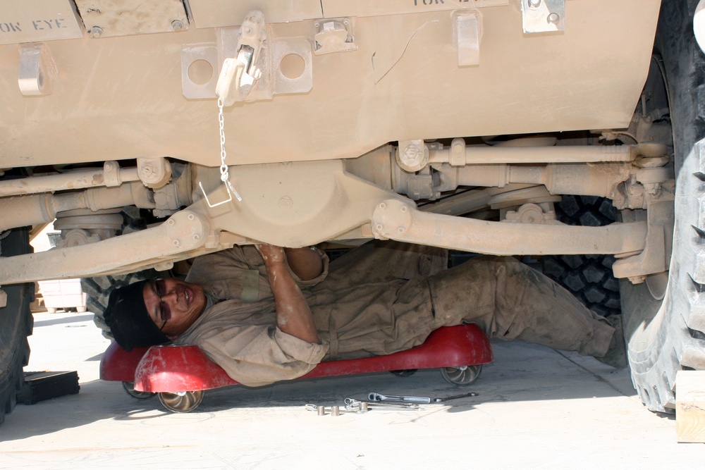Cavalry soldiers maintain vehicles