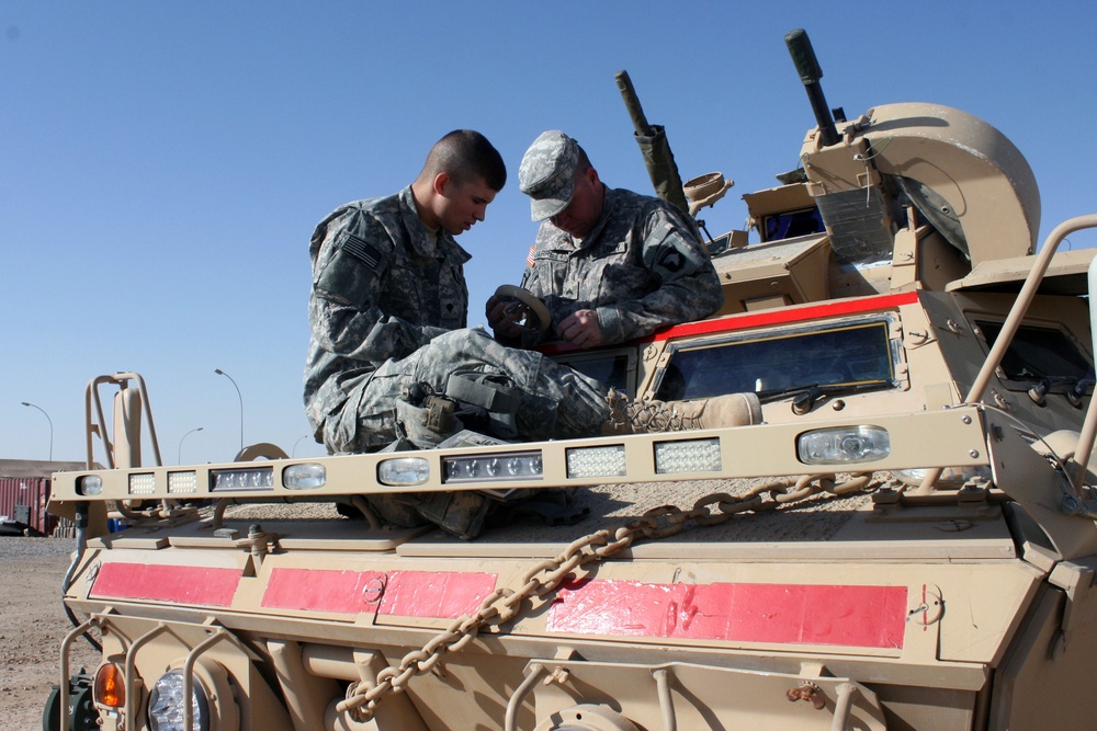 Cavalry soldiers maintain vehicles
