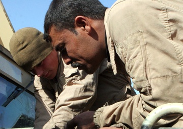Marines With Maintenance Company, Combat Logistics Battalion 2, 1st Marine Logistics Group, Conducted an Iraqi Partnership Dec. 31, 2008. the CLB-2 Mechanics Taught Iraqis Basic Vehicle Maintenance.