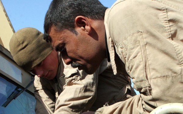 Marines With Maintenance Company, Combat Logistics Battalion 2, 1st Marine Logistics Group, Conducted an Iraqi Partnership Dec. 31, 2008. the CLB-2 Mechanics Taught Iraqis Basic Vehicle Maintenance.