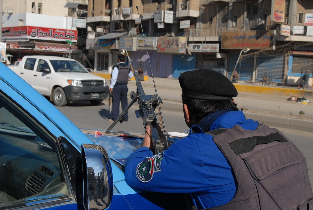 Iraqi police step forward as 8th Military Police Brigade Soldiers provide overwatch