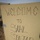 Activities at Al Asad Air Base A handwritten sign on a wooden board reads 'WELCOME TO SAHL SINJAR', placed outdoors in a sandy/dusty environment. The sign appears to mark an entry point to Sahl Sinjar, a plain region near Sinjar in northwestern Iraq. The lettering is hand-drawn in black marker with varied stylistic characters.