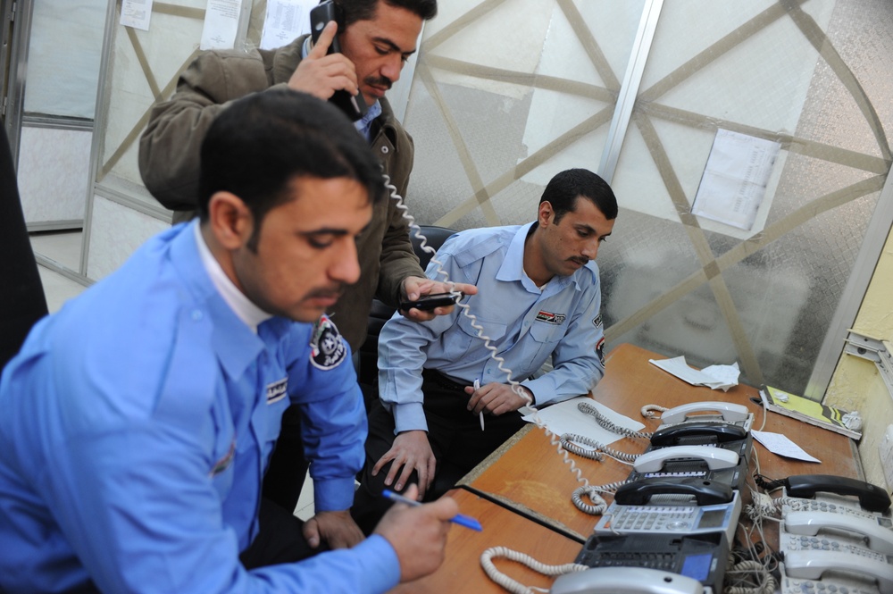 Iraqi police dispatch calls at Provincial Joint Coordination Center