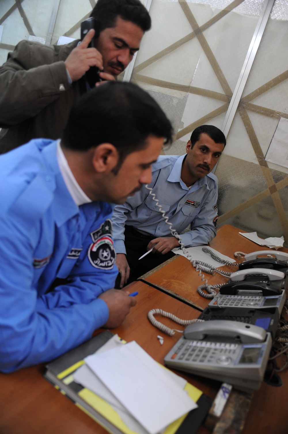 Iraqi police dispatch calls at Provincial Joint Coordination Center