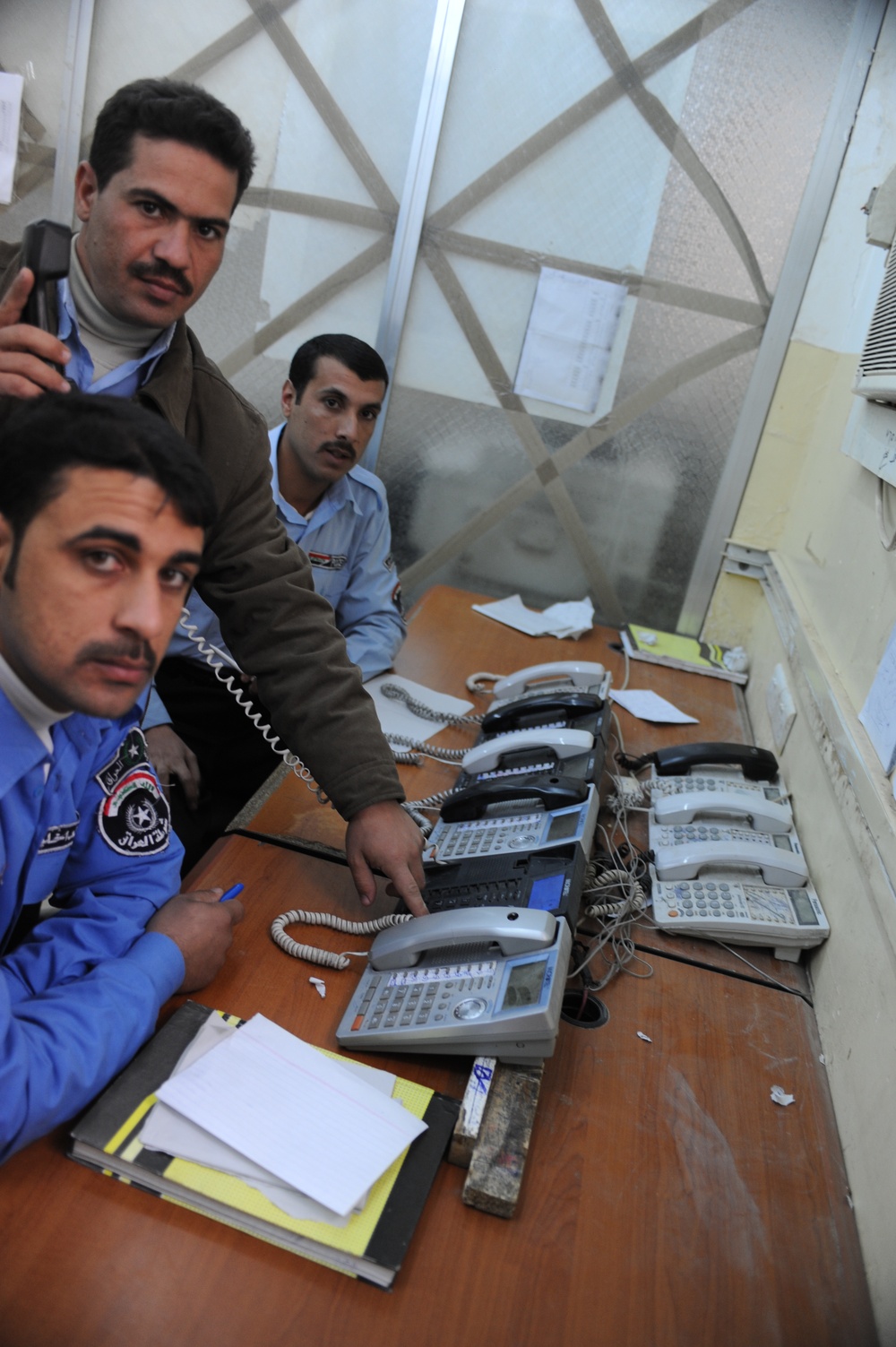 Iraqi police dispatch calls at Provincial Joint Coordination Center