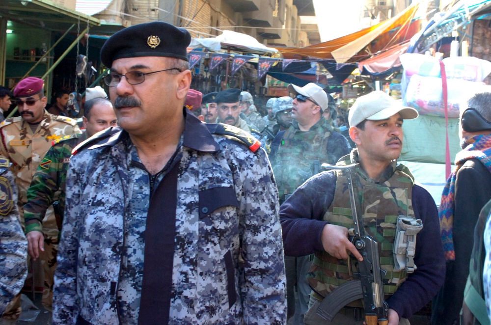 National police lead patrol during market visit