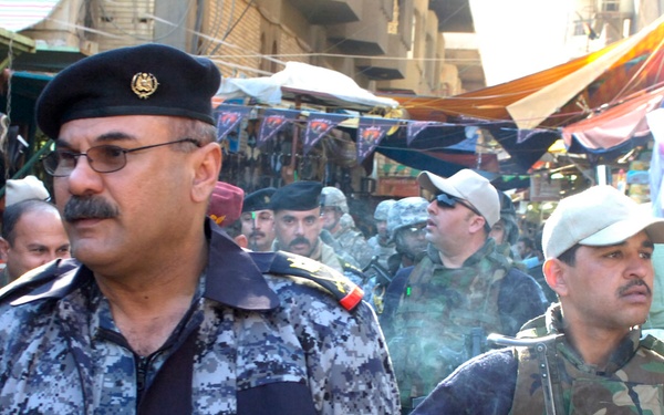 National police lead patrol during market visit