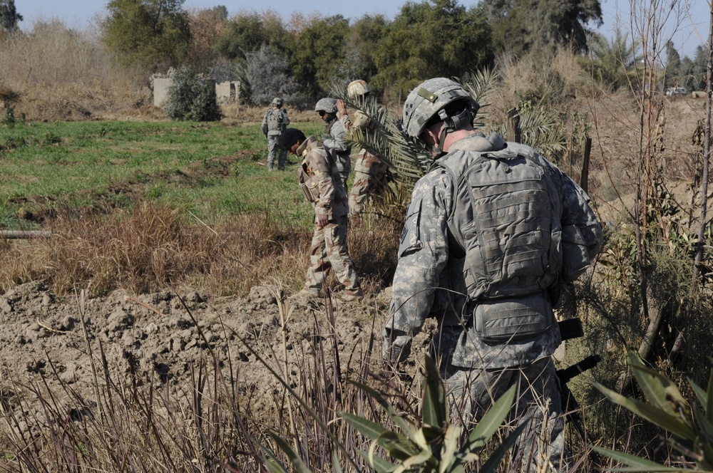 Neighborhood presence patrol, weapons cache search in Baghdad