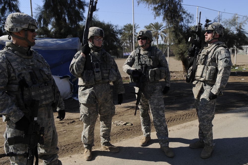Neighborhood presence patrol, weapons cache search in Baghdad