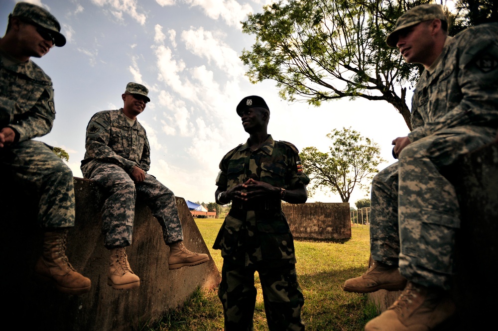 U.S. Soldiers Attached to Combined Joint Task Force-Horn of Africa Talk to a Uganda Peoples Defense Force Soldier in Jinja.