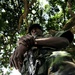 A Uganda Peoples Defense Force soldier Stands Beneath a Tree During a Demonstration of Skills Learned During the UPDF Non-Commissioned Officers Academy in Jinja.