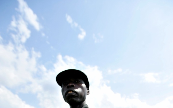 A Uganda Peoples Defense Force Soldier Stands in a Field During a Demonstration of Skills Learned During the UPDF Non-Commissioned Officers Academy in Jinja.