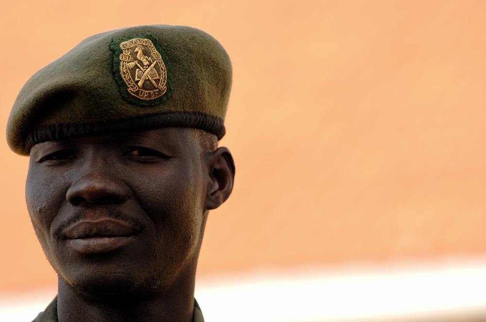 A Uganda Peoples Defense Force Soldier Stands in Front of Officer Cadet's Barracks Before Attending a Graduation Ceremony for the UPDF Non-Commissioned Officers Academy