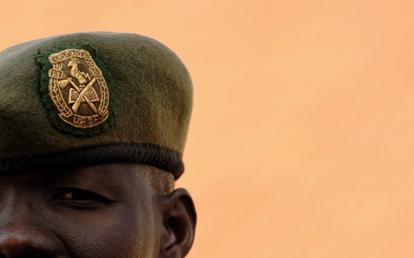A Uganda Peoples Defense Force Soldier Stands in Front of Officer Cadet's Barracks Before Attending a Graduation Ceremony for the UPDF Non-Commissioned Officers Academy