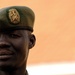 A Uganda Peoples Defense Force Soldier Stands in Front of Officer Cadet's Barracks Before Attending a Graduation Ceremony for the UPDF Non-Commissioned Officers Academy