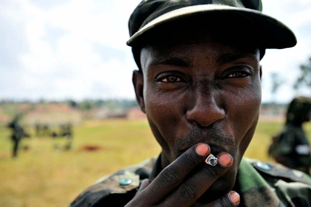 A Uganda Peoples Defense Force Soldier Smokes a Cigarette After a Demonstration of Skills Learned During the UPDF Non-Commissioned Officers Academy in Jinja.