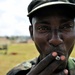 A Uganda Peoples Defense Force Soldier Smokes a Cigarette After a Demonstration of Skills Learned During the UPDF Non-Commissioned Officers Academy in Jinja.