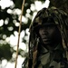 A Uganda Peoples Defense Force soldier Stands Beneath a Tree During a Demonstration of Skills Learned During the UPDF Non-Commissioned Officers Academy in Jinja.