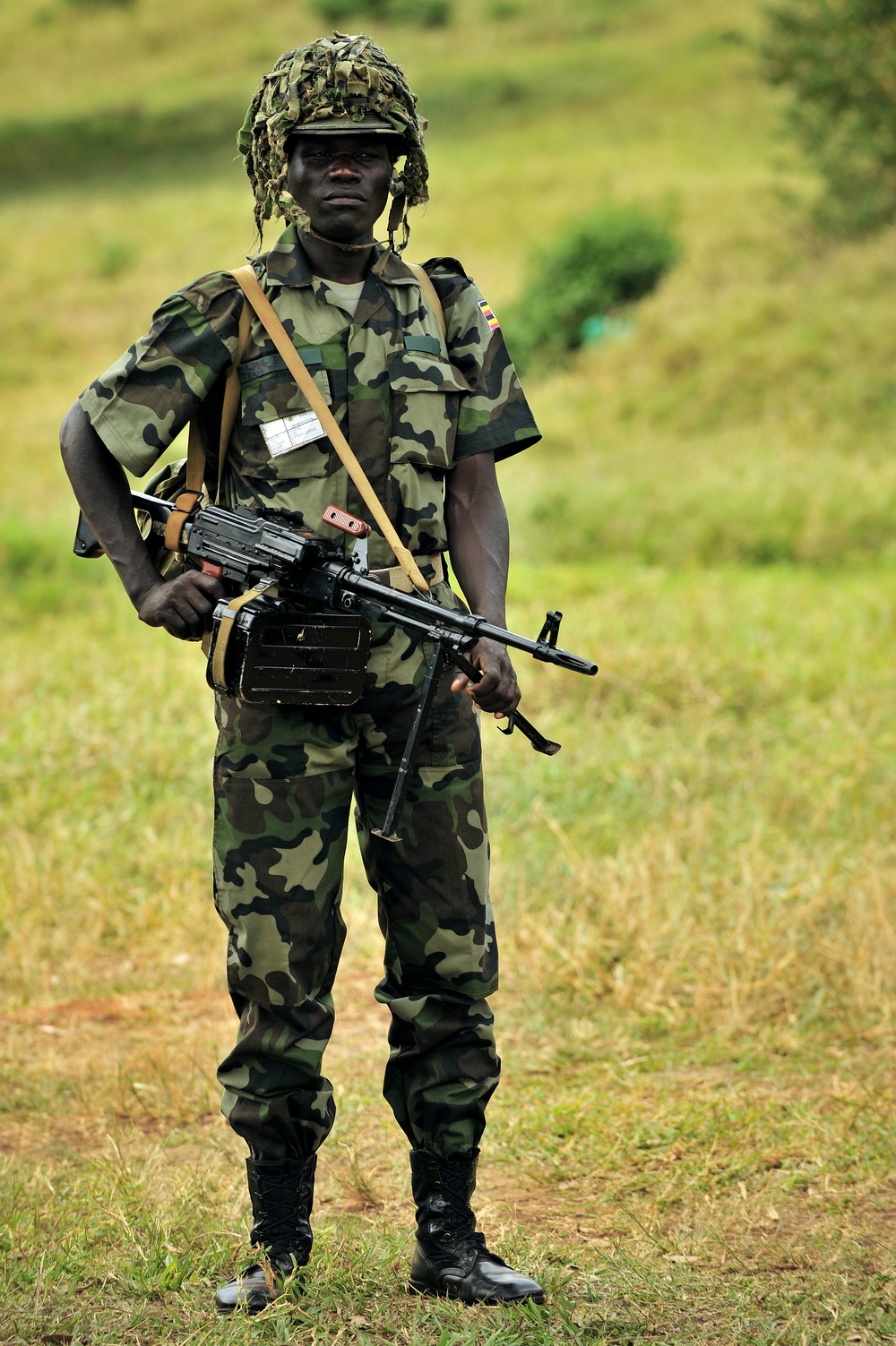 A Uganda Peoples Defense Force Soldier Stands in a Field During a Demonstration of Skills Learned During the UPDF Non-Commissioned Officers Academy in Jinja.