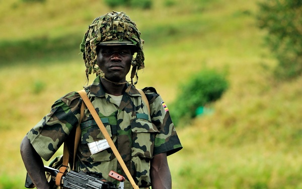 A Uganda Peoples Defense Force Soldier Stands in a Field During a Demonstration of Skills Learned During the UPDF Non-Commissioned Officers Academy in Jinja.