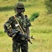 A Uganda Peoples Defense Force Soldier Stands in a Field During a Demonstration of Skills Learned During the UPDF Non-Commissioned Officers Academy in Jinja.