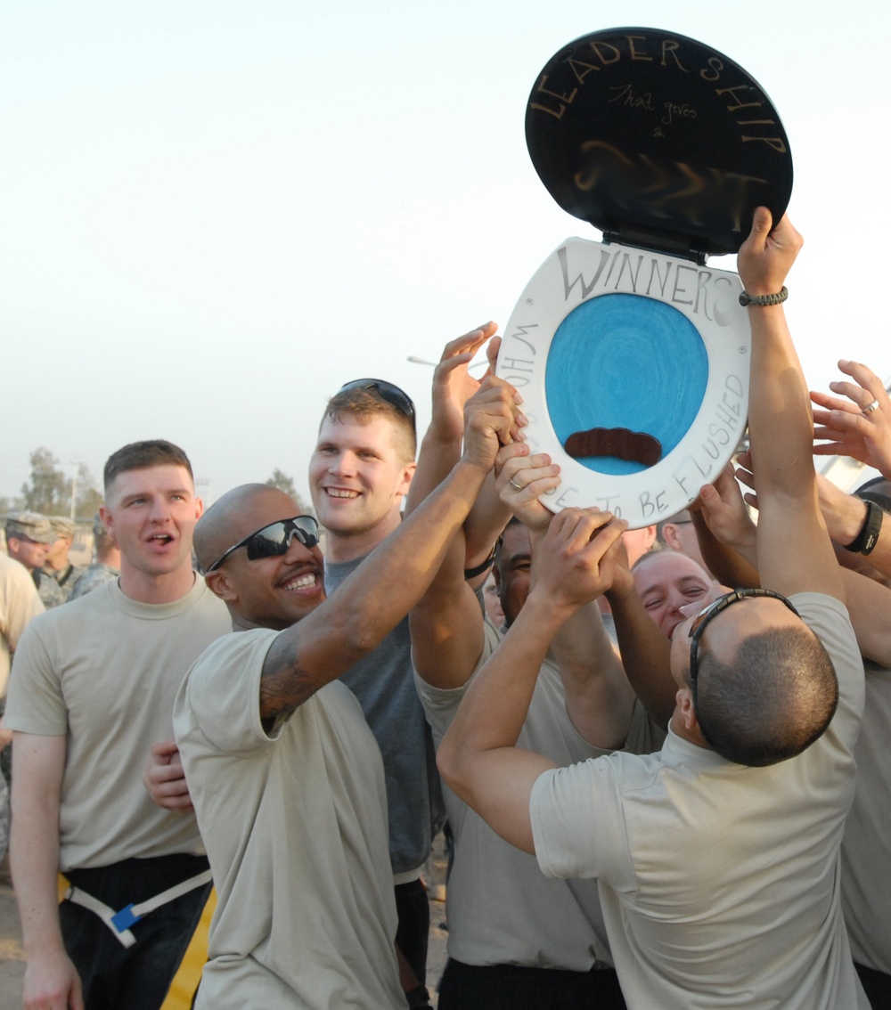 Guard Non-commissioned Officers Raise 'trophy' Following Flag-football Game Vs. Officers