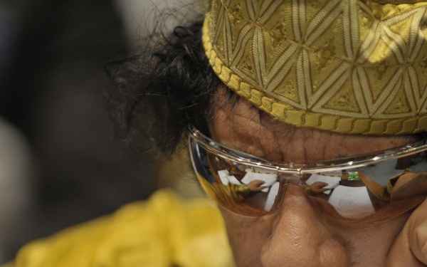 Muammar Gaddafi, Leader of the Revolution of the Great Socialist People's Libyan Arab Jamahiriya, Sits Reading in the Plenary Hall of the United Nations (UN) Building in Addis Ababa, Ethiopia, During the 12th African Union (AU) Summit